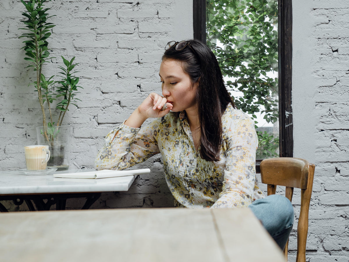 focused-young-asian-woman-thinking-about-project-in-4350177