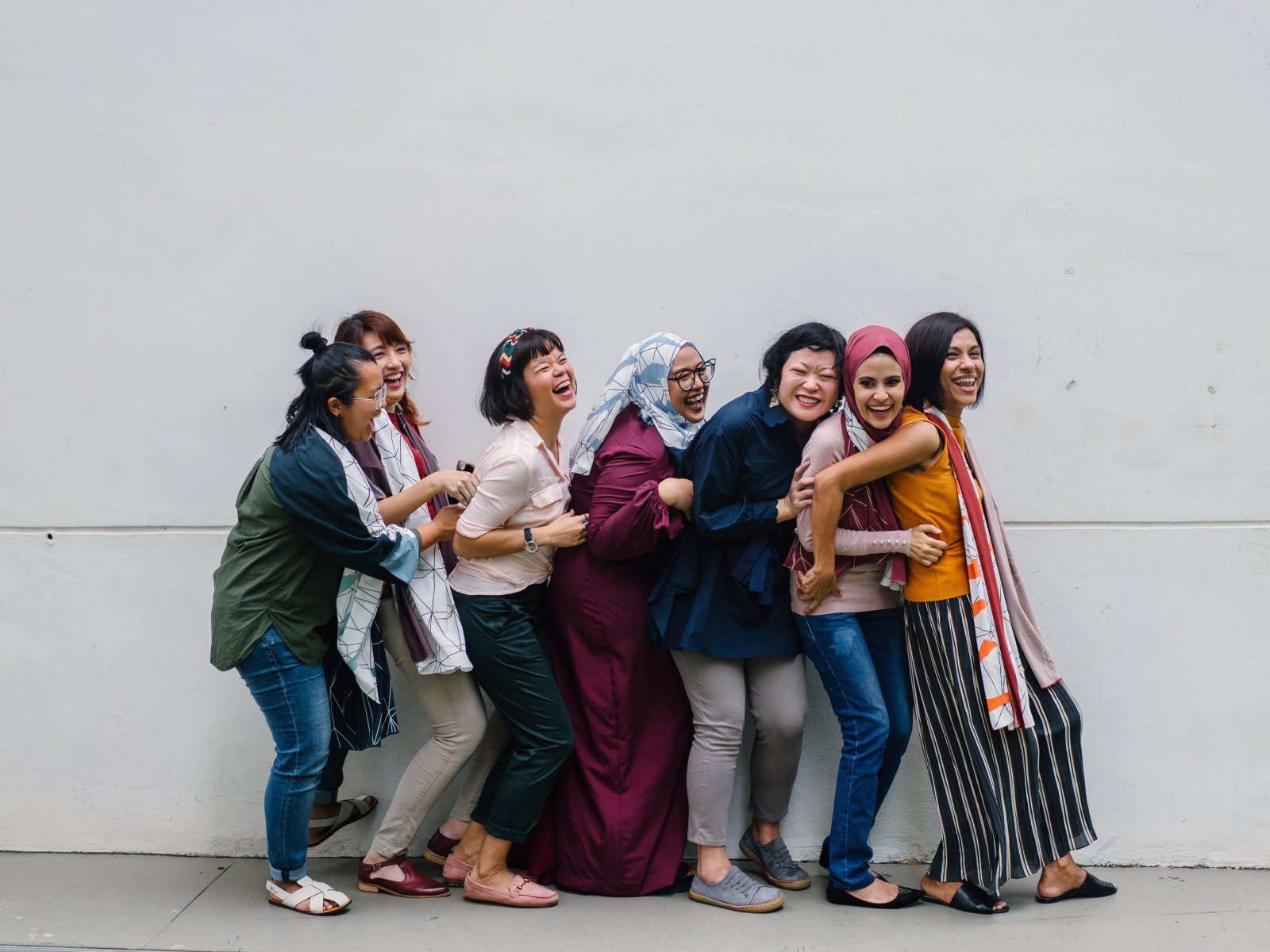 woman-falling-in-line-holding-each-other-1206059